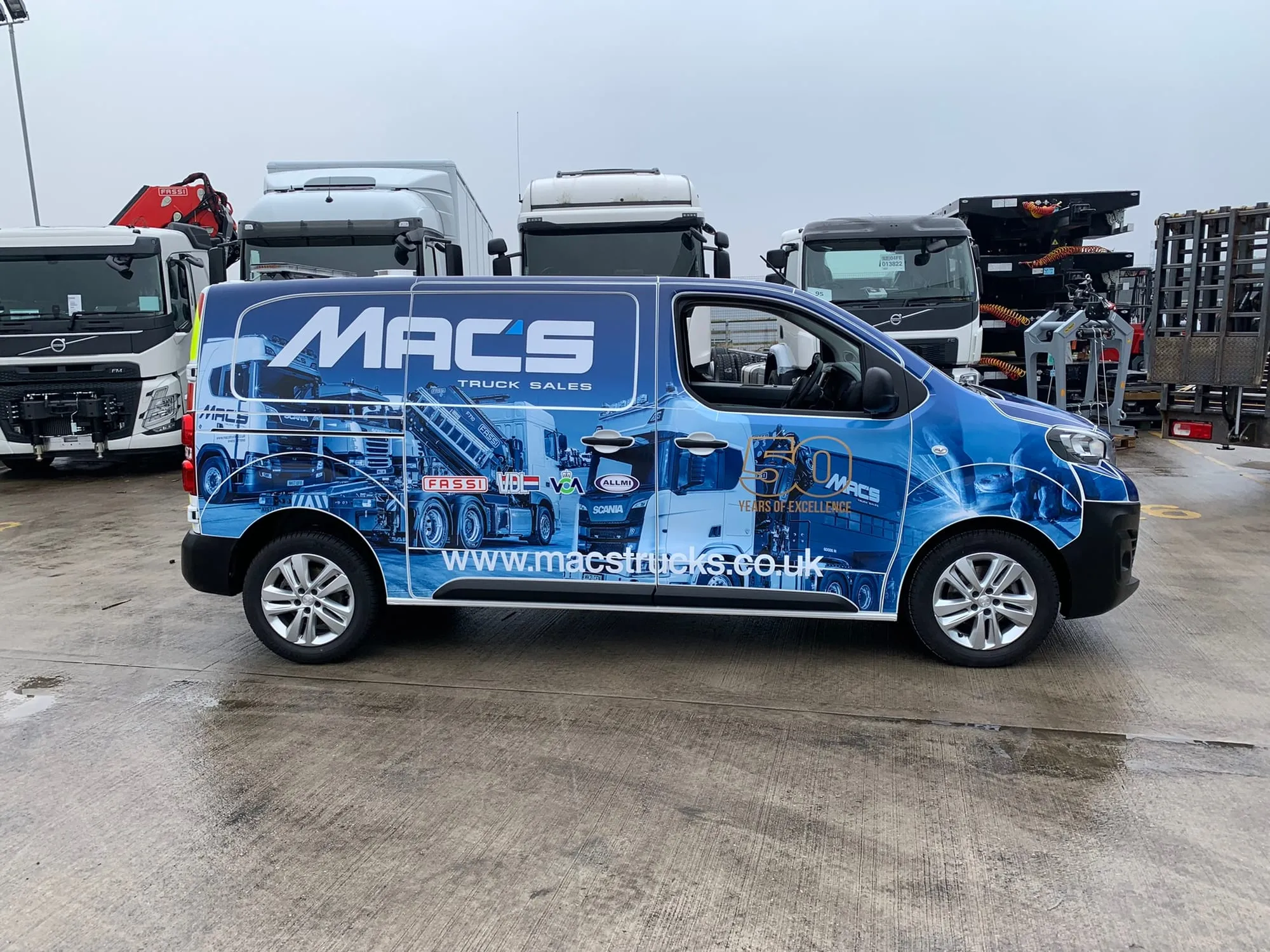 Blue van with photographic graphics along the full length of the side