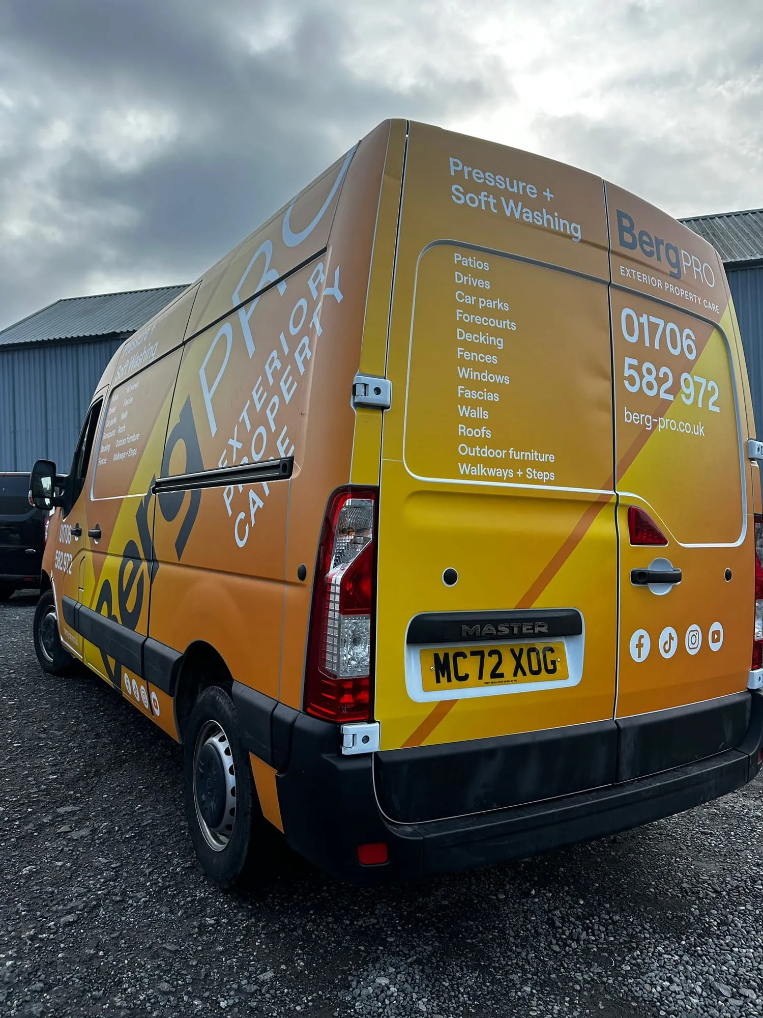 Rear of an orange and yellow van listing the services offered