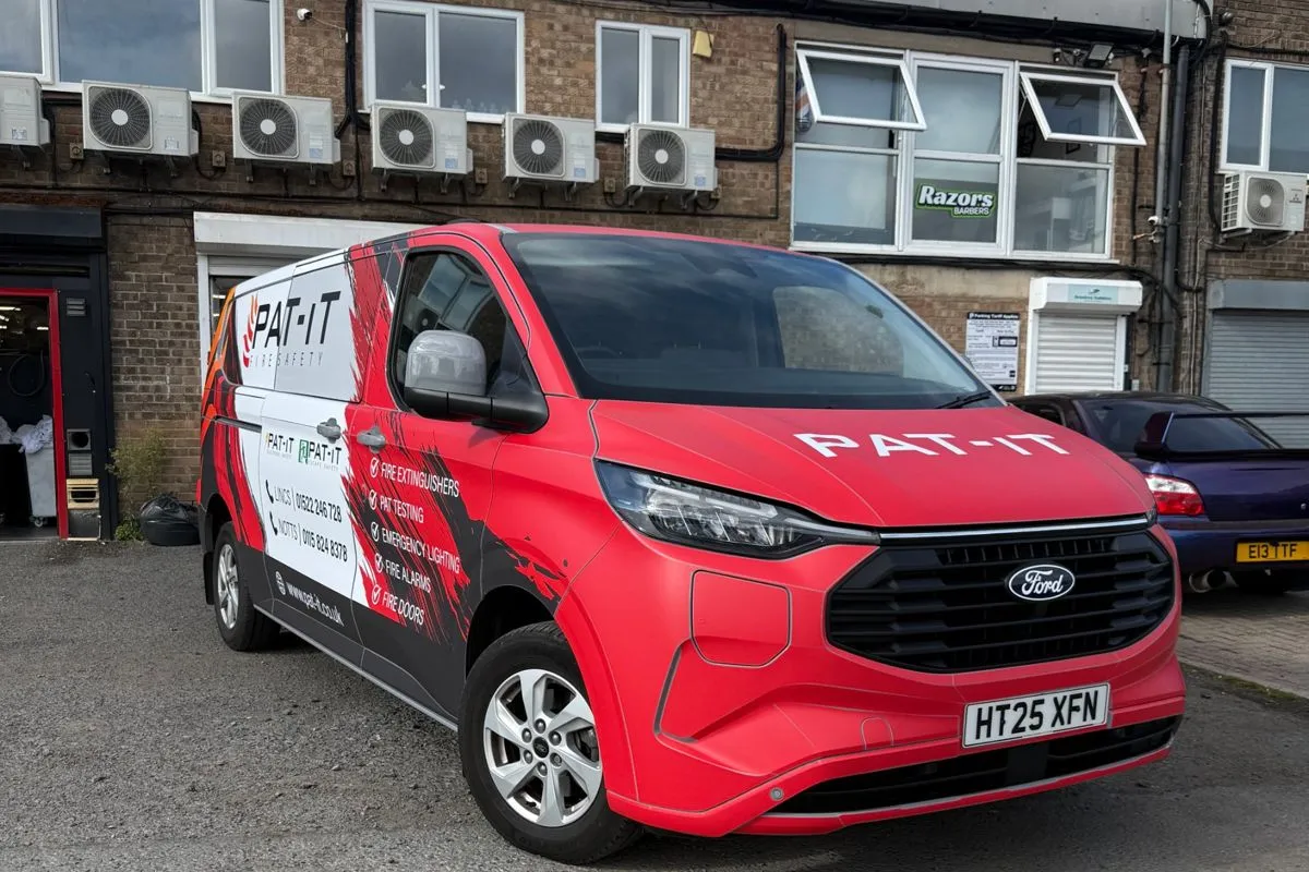 Front view of the PAT-IT wrapped van with matching bumper